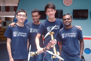 Team Hogmanayers (from left) Dai Siyuan, Francis Xavier Erickinsen, Lim Wei Liang, and Selvaraj Pichamuthu, at the Singapore Amazing Flying Machine Competition 2014 Awards ceremony held on 22 March 2014. Lim Wei Liang holds their tri-copter which took first place in the best video award for the semi-automated category. Photo | UOG A/Prof Sutthipong Srigrarom