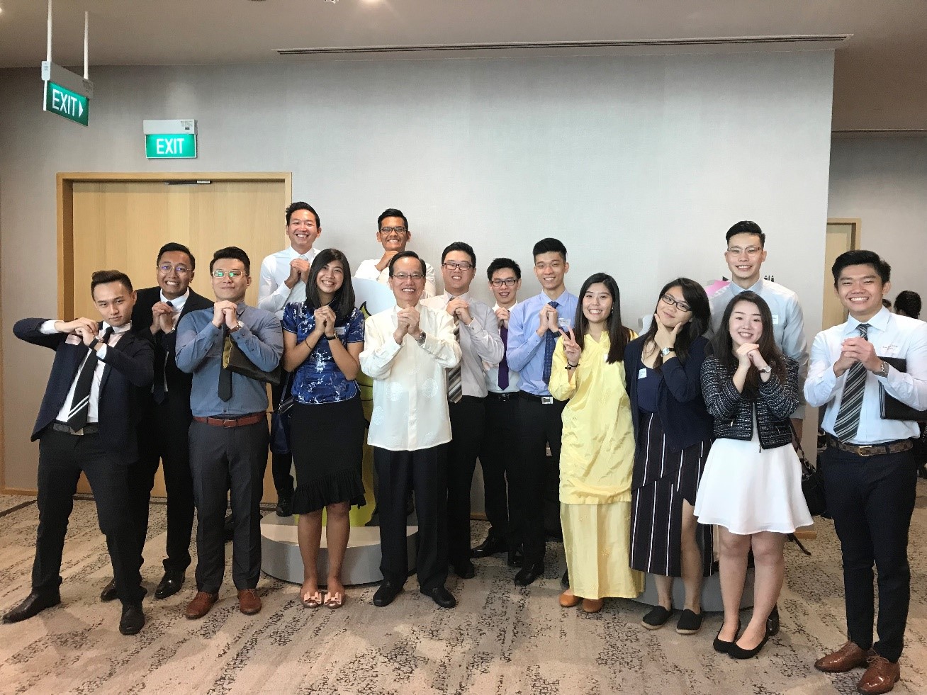 Mr Patrick Lee (fourth from left in the front row), with some of the Yangzheng Foundation Bursary recipients at a community event in 2018.