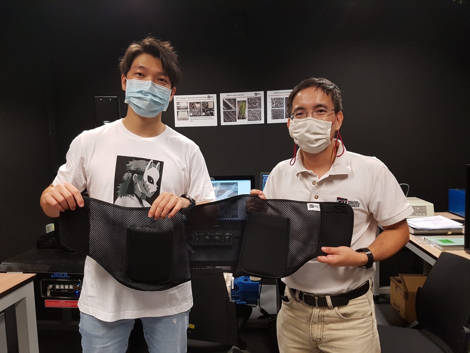 Associate Professor Soh Chew Beng (right), Programme Leader, Sustainable Infrastructure Engineering (Building Services), SIT and Mr Samuel Lim, former Research Engineer at SIT, displaying the hip protector belts in the characterisation lab at SIT@Dover, where they performed material characterisation.
