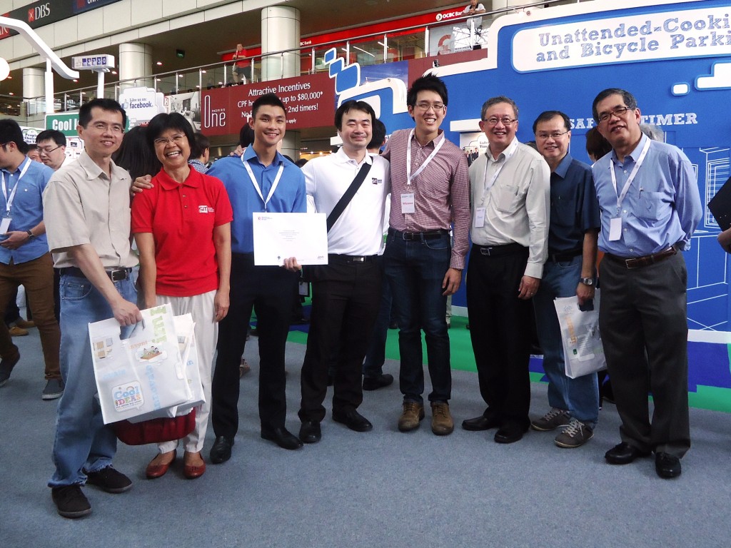 Team SITuations celebrates winning second place along with SIT staff at the Cool Ideas for HDB Living 2014 Exhibition on 29 March 2014 at HDB Hub. (From left) Asst Prof Alfred Tan, Kathrine Koo, Director, Student Life; Alex Woh Yu Ker, member of team SITuations; Asst Prof Edmund Liew, Programme Director; Ernest Fong Tze Chow, leader of team SITuations; Prof Loh Han Tong, Vice-Provost; Woon Kok Meng, Director (Programmes Administration) and Programme Director; Prof Tan Thiam Soon, President, SIT. Photo | SIT Sarah Loh