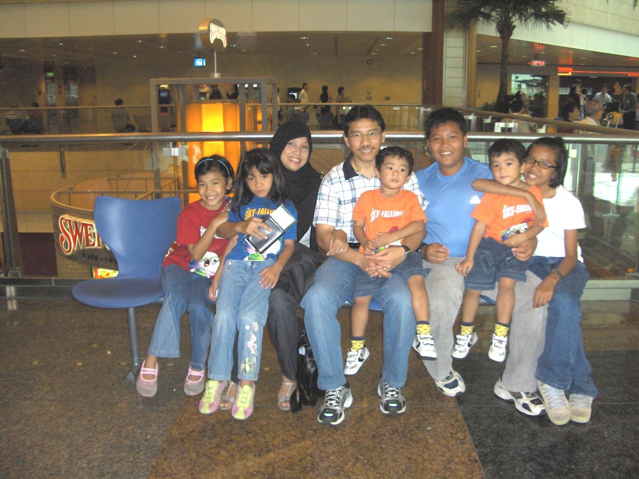 Arifalina (in red on the extreme left) with her family at Changi Airport Terminal 2. Weekends and birthday meal celebrations were also he