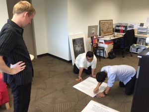 Heng and Chan putting the final touches to the tribute posters of the late Mr Lee Kwan Yew