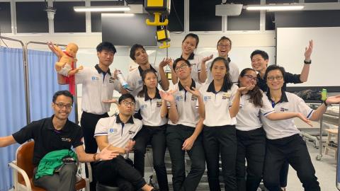 A/Prof Kwah (top row, first from the right) hanging out in the classroom with her students. Photo taken pre-COVID.